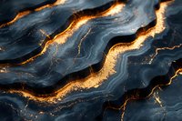 Dark navy blue marble texture with golden veins and cracks creating luxurious wavy pattern. Abstract natural stone background with glowing metallic accents.