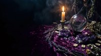 Mystical fortune telling setup with crystal ball, burning candle, tarot cards and dried herbs on purple velvet cloth creating atmospheric divination scene.