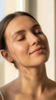 Young woman with olive skin tone and dark hair, eyes closed in peaceful expression, minimal makeup, natural lighting for skincare, wellness, and beauty campaigns.
