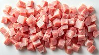 Fresh raw pork meat cubes cut into uniform pieces on white background, ready for cooking. Culinary preparation of diced lean meat for stew or kebab.