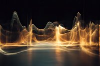 Abstract golden light waves flowing over reflective surface create dynamic energy pattern against dark background, glowing with ethereal movement and luminous motion.