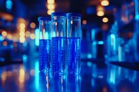 Laboratory test tubes with blue liquid in modern research facility with bokeh lights creating scientific atmosphere for medical studies.