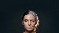 Young woman face showing aging process transformation from youth to elderly with wrinkles and gray hair on dark background for skincare concepts.