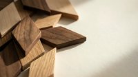 Scattered wooden square pieces on a light surface, natural texture and warm tones, concept of strategy, creativity, and problem solving.