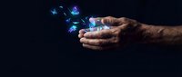 Male hand holding smartphone with glowing blue digital icons and data symbols floating upward against dark background, representing mobile technology and connectivity.
