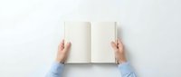 Hands holding open blank notebook with empty white pages on clean surface, top view perspective for mockup and template design projects.