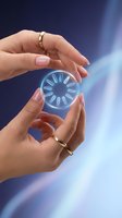Woman's hands holding glowing neon loading circle against blue background. Futuristic technology concept for web design, app development, and digital innovation projects.