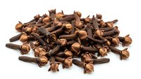 Whole cloves spice pile isolated on white background for culinary cooking seasoning and aromatic flavoring in kitchen recipes and food preparation.
