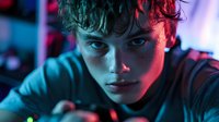 Young male teenager with fair complexion and dark hair, illuminated by neon blue and pink lighting in a modern digital environment, suitable for tech, gaming, and youth culture projects.