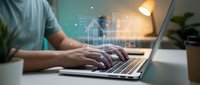 Person working on laptop with digital house hologram and network connections for real estate technology and smart home automation concepts.