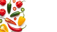 Colorful fresh peppers and chili varieties isolated on white background for cooking, spice blends, healthy eating and culinary ingredient designs.