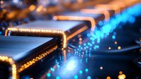 Glowing circuit board with orange and blue light trails creating futuristic technology pattern, macro photography showing electronic components and data flow paths.