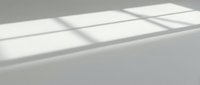 Minimalist white surface with geometric window shadows cast across clean, modern interior space for contemporary design projects.