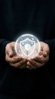 Mature male hands holding glowing shield icon symbolizing cybersecurity, data protection, and digital safety against dark background for business and technology concepts.