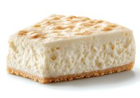 Creamy vanilla cheesecake slice with golden graham cracker crust on white background, showing rich texture and delicate air bubbles in smooth filling.