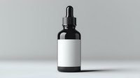 Black glass dropper bottle with blank white label on gray background, isolated product mockup for cosmetic, pharmaceutical or essential oil packaging design.