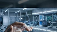 Technician hand holding digital holographic data visualization with network lines in modern industrial laboratory or tech facility environment.