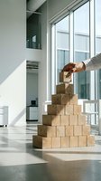 Businessman building wooden block pyramid with trust concept in modern office environment for leadership and team development strategies.