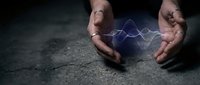 Protective hands cupping glowing blue energy waves on dark textured surface symbolizing power, innovation and technological advancement in business.
