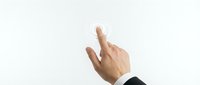 Male hand in business suit pointing upward with index finger on clean white background for presentations and corporate communications.