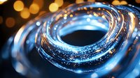 Glowing blue spiral light trail with bokeh effect on dark background creates futuristic abstract composition with luminous energy motion pattern.