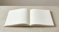 Open blank notebook with empty white pages on neutral beige surface for writing, journaling, planning, education and creative projects.