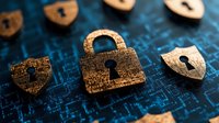 Golden padlock and shield symbols on digital circuit background representing cybersecurity, data protection, and network safety in technology concept.