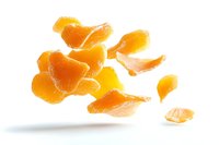 Fresh mandarin orange segments floating in air against white background, juicy citrus slices with bright color and natural texture, isolated for commercial use.