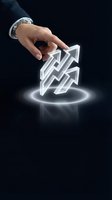 Businessman hand touching glowing white arrows pointing upward on dark background representing growth strategy and success direction.