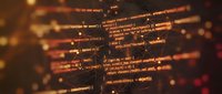 Programming code on screen with warm orange glow, software development concept for web design and technology projects.