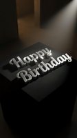 Silver metallic text reading "Happy Birthday" sits on a black surface with dramatic lighting and shadows, suitable for greeting cards, invitations, and celebration designs.