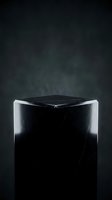 Elegant black marble pedestal display stand with dramatic lighting against dark smoky background for luxury product presentation and premium branding.