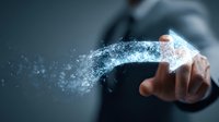 Businessman touching glowing digital arrow made of particles and light effects on dark background, representing business growth and digital transformation.