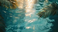 Tranquil underwater scene with golden sunlight streaming through palm fronds, creating ethereal reflections and patterns on rippling turquoise water surface.