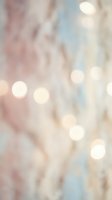 Soft pastel bokeh background with warm pink and blue tones, glowing light circles creating dreamy atmosphere for wedding invitations and romantic designs.