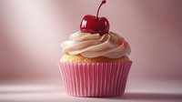 Pink vanilla cupcake with swirled cream frosting topped with fresh red cherry against soft pink background, showcasing delicate bakery details and appetizing textures.