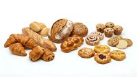 Assorted fresh baked goods including croissants, bread loaves, pastries, cookies and muffins isolated on white background for bakery, food and culinary design projects.