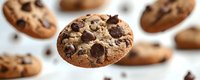 Freshly baked chocolate chip cookies with golden brown texture and melted chocolate chunks scattered on white surface for bakery marketing.