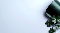 Green shamrock clovers and satin ribbon on white background with copy space, perfect for St. Patrick's Day holiday designs.