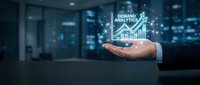 Businessman holding demand analytics hologram with growth chart in modern office environment for business intelligence and data analysis.
