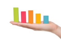Female hand holding colorful bar graph chart showing declining trend, isolated on white background. Business analytics and statistics concept.