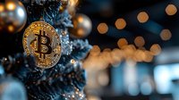 Golden bitcoin cryptocurrency coin hanging as Christmas tree decoration with silver baubles and bokeh lights in blue tones, festive crypto background.