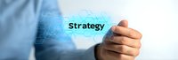 Business professional pointing at glowing strategy text on futuristic digital interface with hexagonal pattern in blue technology background.