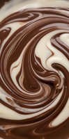 Swirled chocolate and vanilla cream creating mesmerizing marbled patterns for dessert preparation and confectionery backgrounds.