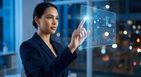 Professional Asian businesswoman interacting with futuristic holographic interface displaying data analytics in modern office environment at night.