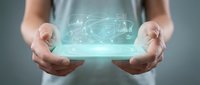 Person holding glowing digital brain hologram with neural network connections floating above hands representing artificial intelligence and technology.