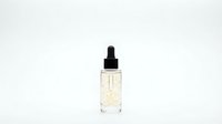 Luxury skincare serum bottle with golden flakes in clear glass dropper container isolated on white background for cosmetic product design.