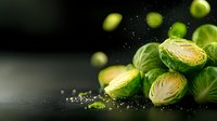 Fresh Brussels sprouts with water droplets on dark surface, healthy organic vegetables for cooking and nutrition concepts.