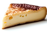 Slice of traditional Basque cheesecake with caramelized burnt top, creamy center and characteristic holes in dense texture, isolated on white background.