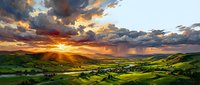 Dramatic sunset over rolling green hills and farmland with golden sunlight breaking through storm clouds above rural landscape.